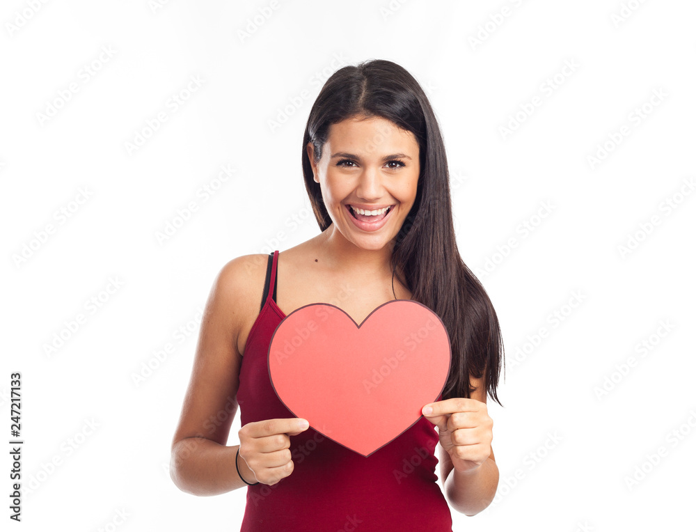 beautiful happy brunette woman holding and showing a big red heart beautiful happy brunette woman holding and showing a big red heart