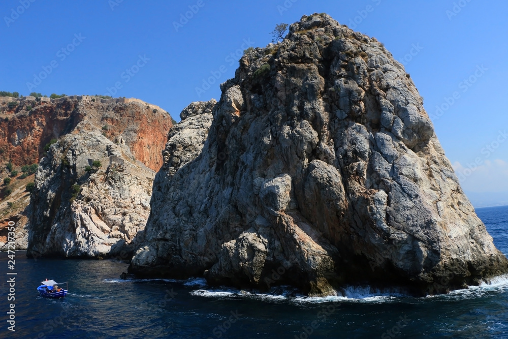 Rocky sea coast with the boat. Rocky sea coast with the boat.