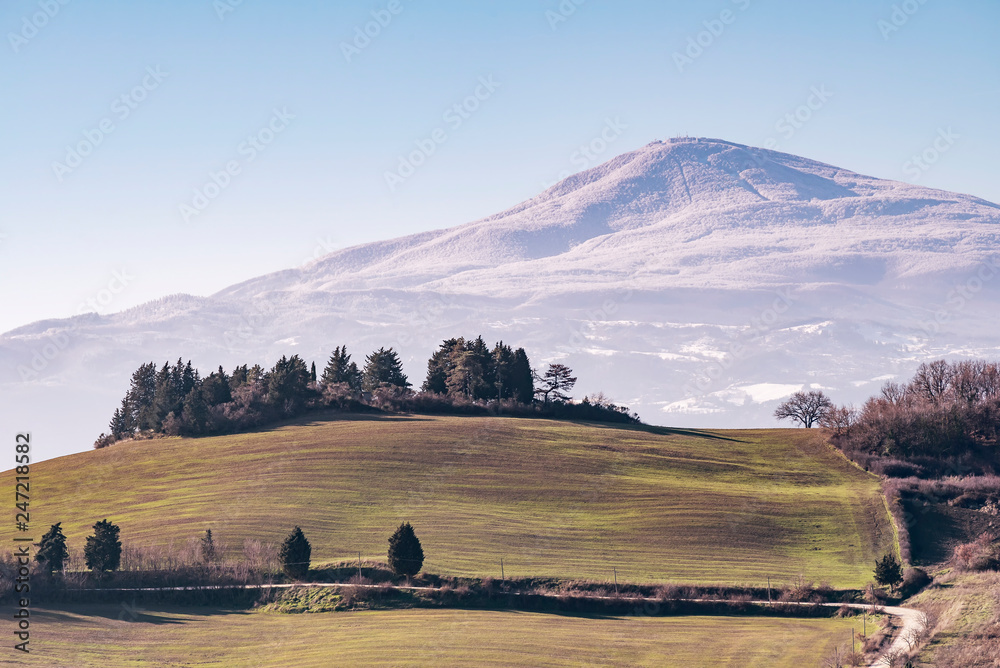 Beautiful panoramic view of Monte Amiata covered with snow from Monticchiello, Siena, Tuscany, Italy