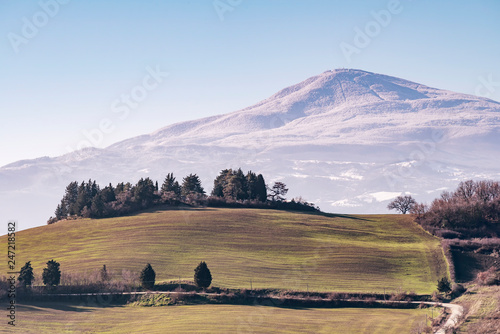 Fototapeta Naklejka Na Ścianę i Meble -  Beautiful panoramic view of Monte Amiata covered with snow from Monticchiello, Siena, Tuscany, Italy