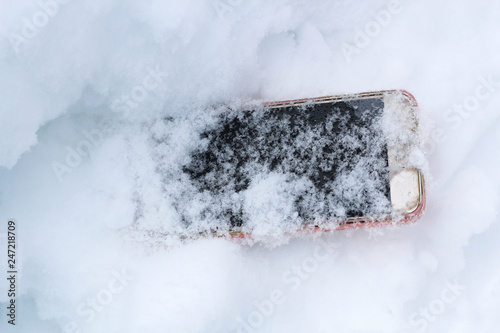 mobile phone accidentally fell out and got lost in the snow