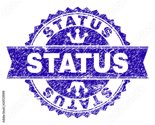 STATUS rosette stamp seal imitation with distress texture. Designed with round rosette, ribbon and small crowns. Blue vector rubber watermark of STATUS title with corroded texture.