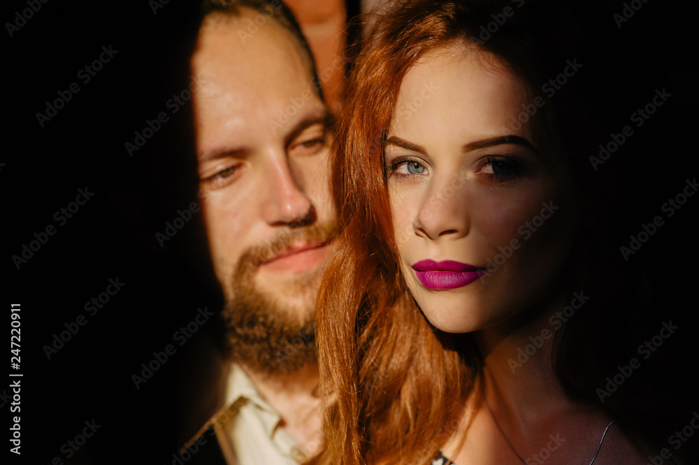Fototapeta premium Fun and a lovely family portrait of a young cheerful joyful couple. Smile and feels happy. Outdoor shot of young beard male with his ginger girlfriend. Love story. Valentine Day