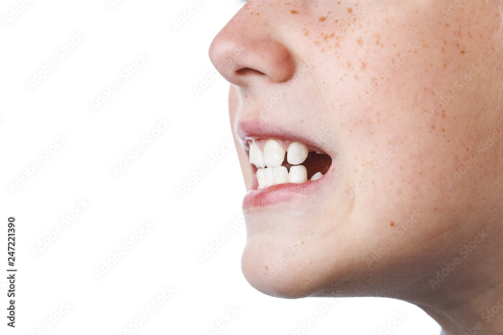Fototapeta premium schoolboy in jacket shows teeth on white
