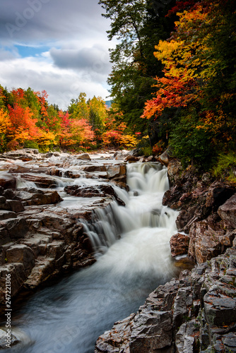 Swift river at rocky scenic gorge area during fall season