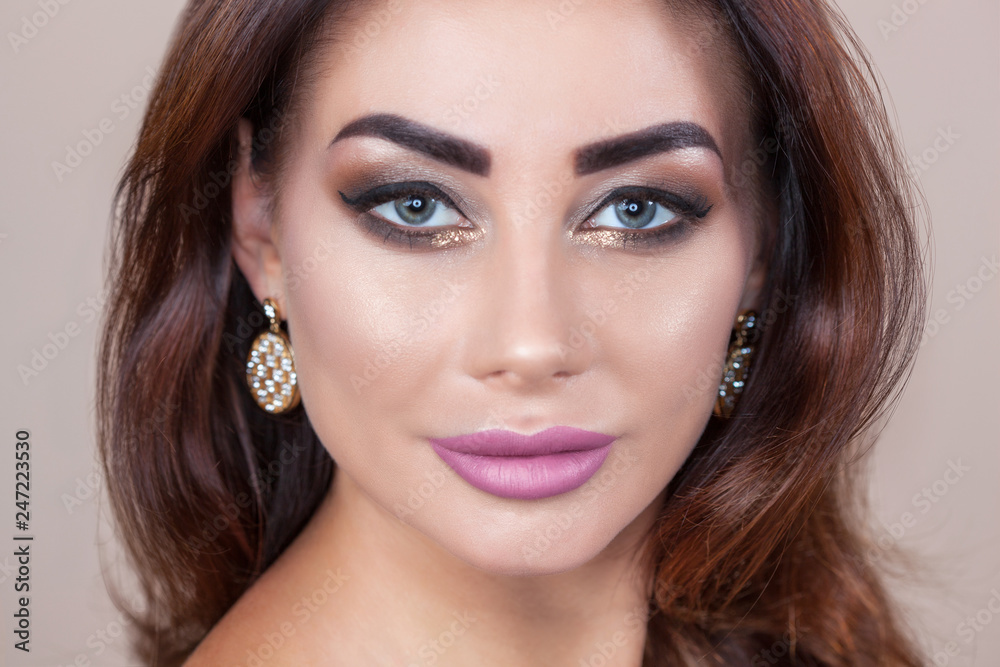 Portrait of attractive young woman with beautiful make-up and manicure. Portrait of attractive young woman with beautiful make-up and manicure.