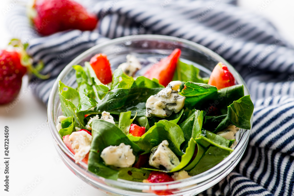 bowl of vegan  salad with strawberries and blue cheese