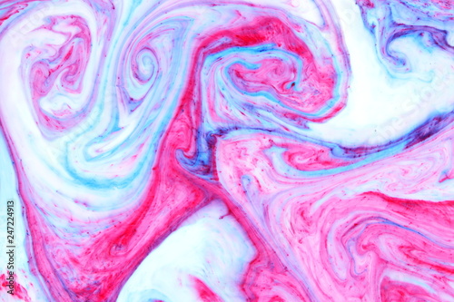 Abstract multicolored background. Fluid art with pink blue color. Blue pink texture. Colored paint stains in liquid