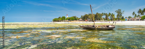 panorama of low tide with lighthouse and boat in Zanzibar island in Tanzania