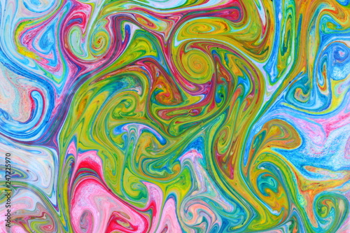 Fluid art with different colors. Multicolored background from paints on liquid. Bright pattern on liquid. Colored paint stains in pop art style