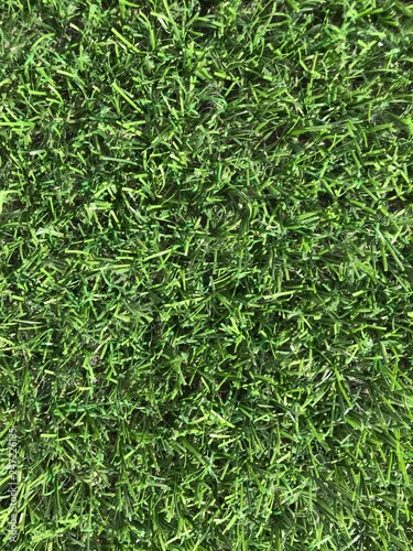 Artificial green grass texture or background top-view close-up