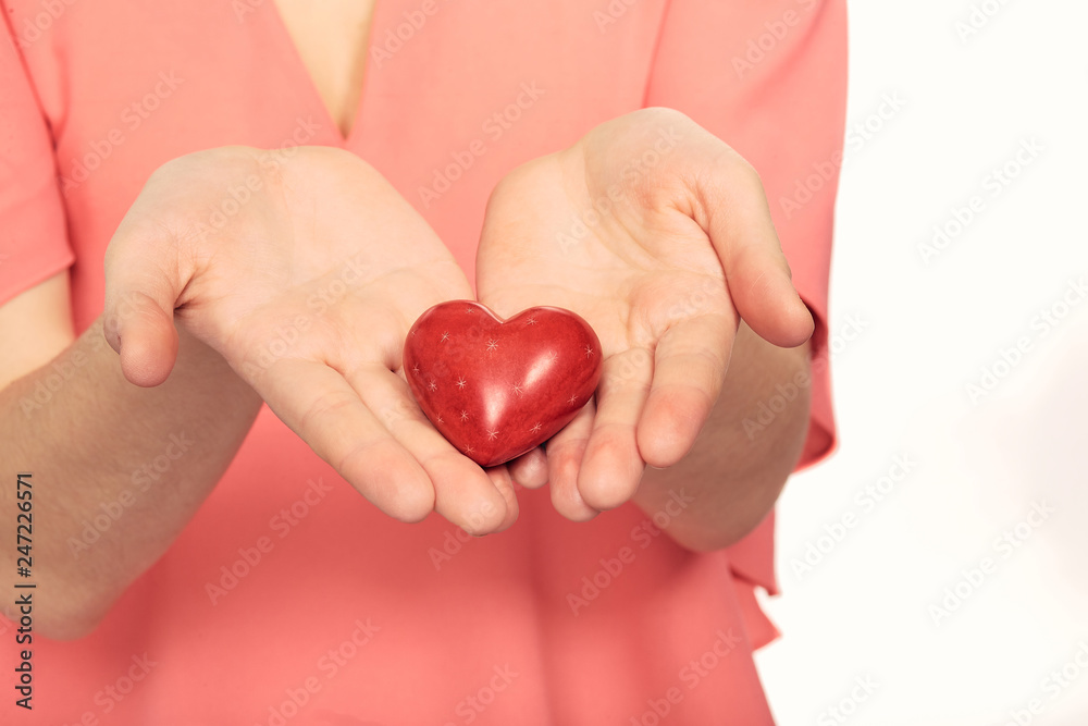 heart in hands on a background of clothes heart in hands on a background of clothes
