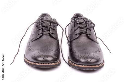 Very closeup of front of black leather male shoes, white background. Men's ankle boot leather isolated on white background. For business and office. Official and casual, footwear. Front view. Isolate