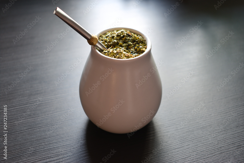 Yerba mate tea in ceramic matero with bombilla on a table Yerba mate tea in ceramic matero with bombilla on a table