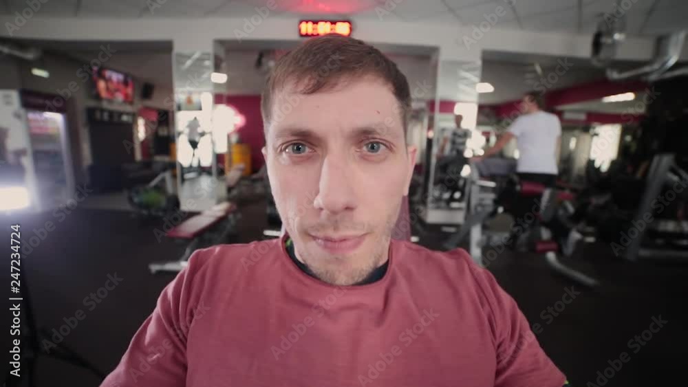 Athletic and attractive man trains pectoral muscles on a simulator in the gym. Athletic and attractive man trains pectoral muscles on a simulator in the gym.