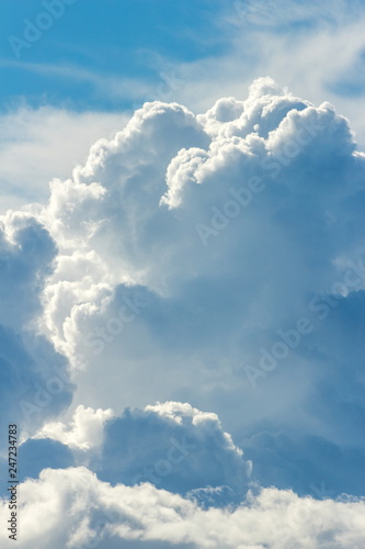 Background image of billowing storm clouds bright blue
