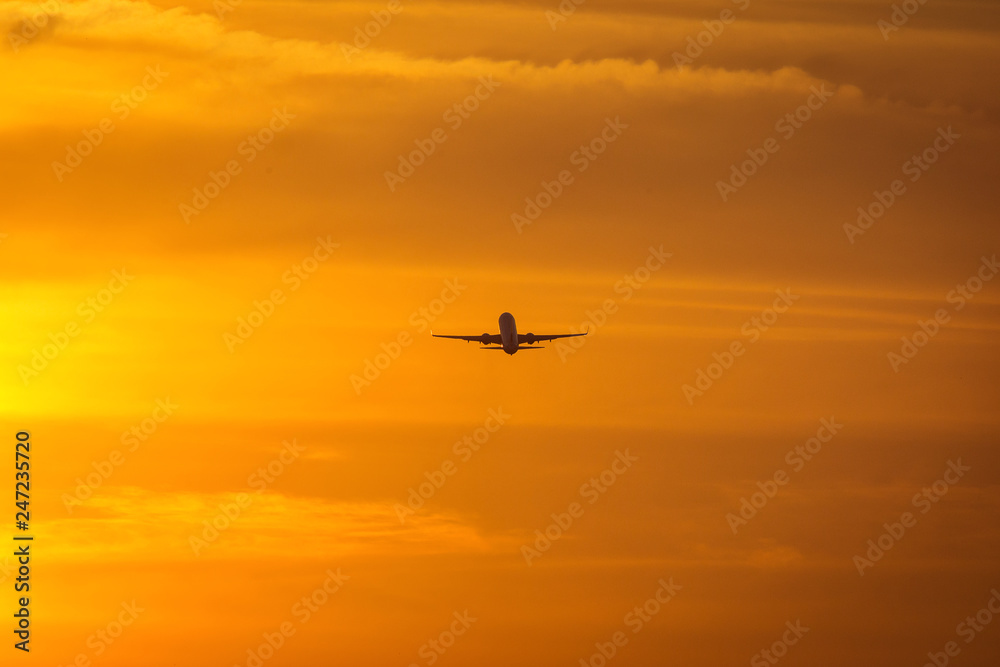 Small plane in the middle of the red clouds at sunset Small plane in the middle of the red clouds at sunset