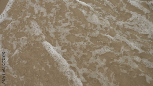 Blue ocean wave on sandy beach