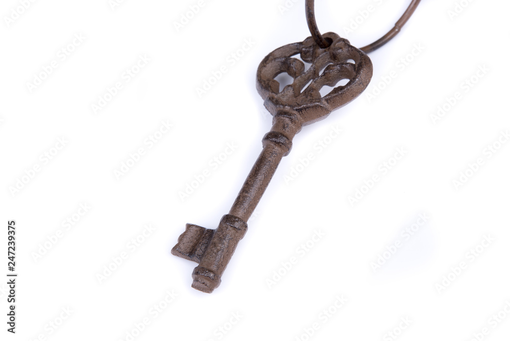 Old key with ring on white background. Isolated old key laying on the background. Top, side view. Close up. Old key with ring on white background. Isolated old key laying on the background. Top, side view. Close up.