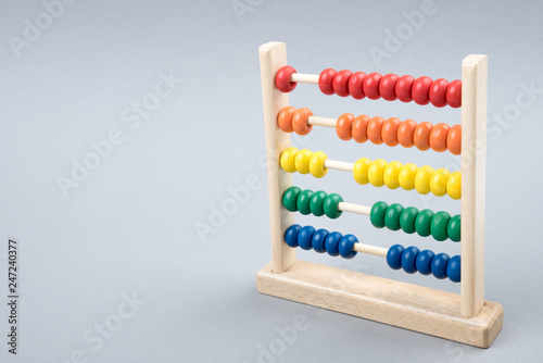 Wooden abacus or abakan. Counting one  two  three  four  five. Counting frame example  great for business concepts. Multicolored wooden abacus. Front view. Place for text. Copy space  