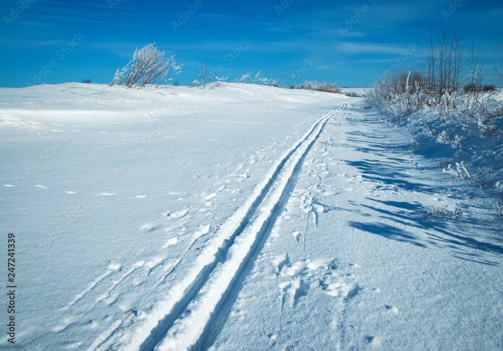 snowy plain with a ski track snowy plain with a ski track