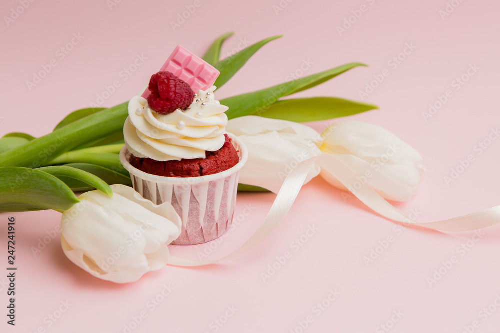cupcake and tulips on pink background.copy spase.Delicious cake cupcake and tulips on pink background.copy spase.Delicious cake