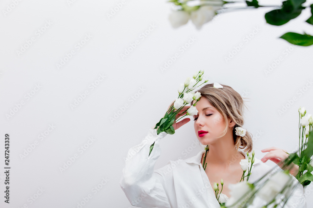 Beautiful woman with white roses in sleeve, dressing in a white dress. Springtime concept or Valentines Day holiday Beautiful woman with white roses in sleeve, dressing in a white dress. Springtime concept or Valentines Day holiday