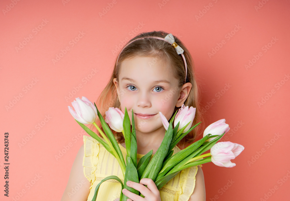 Beautiful young firl in yellow dress holding spring pink flower bouquet ...