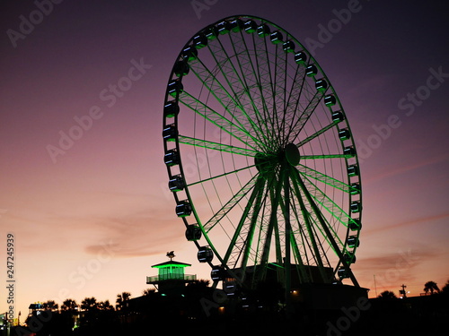 Lighted ferris wheel at dusk