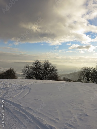 Dense winter clouds above snowy country with ski touring tracks. Location near Selce, Banska Bystrica region, central Slovakia