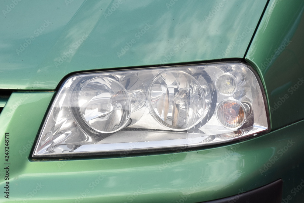 shiny headlight on a green  car