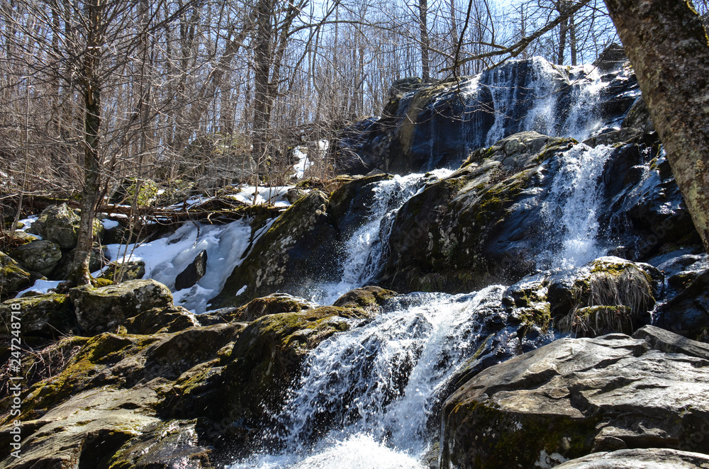 Springtime at Dark Hollow Falls, a waterfall located within Shenandoah National Park in Virginia along Skyline Drive in the Blue Ridge Mountains Springtime at Dark Hollow Falls, a waterfall located within Shenandoah National Park in Virginia along Skyline Drive in the Blue Ridge Mountains