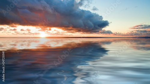 Sea landscape with dramatic sunset views and a large cloud.