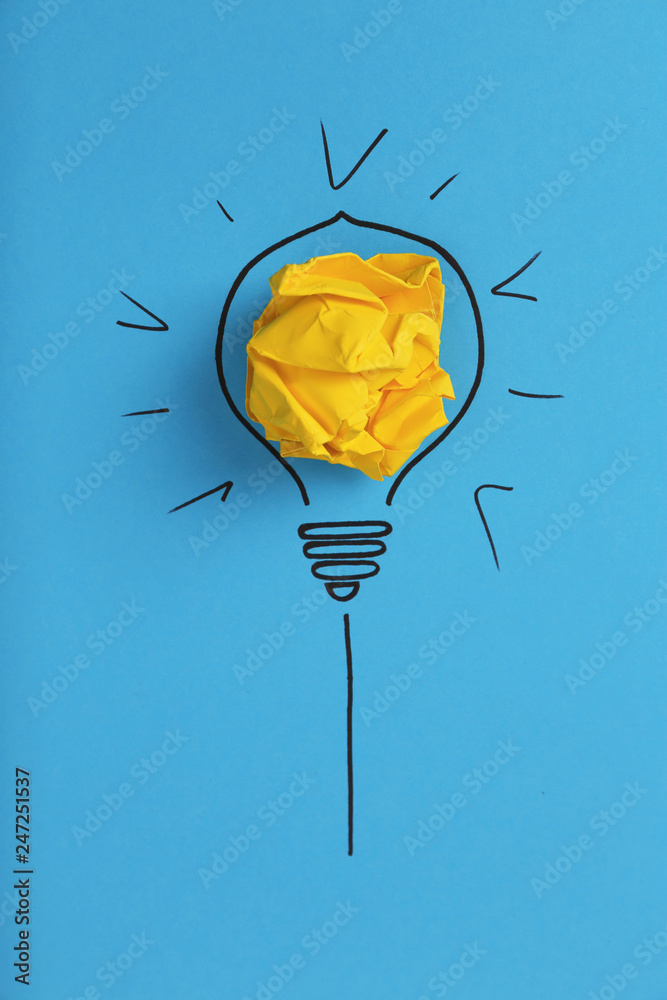 Composition with crumpled paper ball and drawing of lamp bulb on color background, top view. Creative concept - obrazy, fototapety, plakaty 