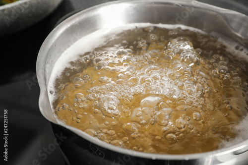 Cooking pasta in pot on stove, closeup view