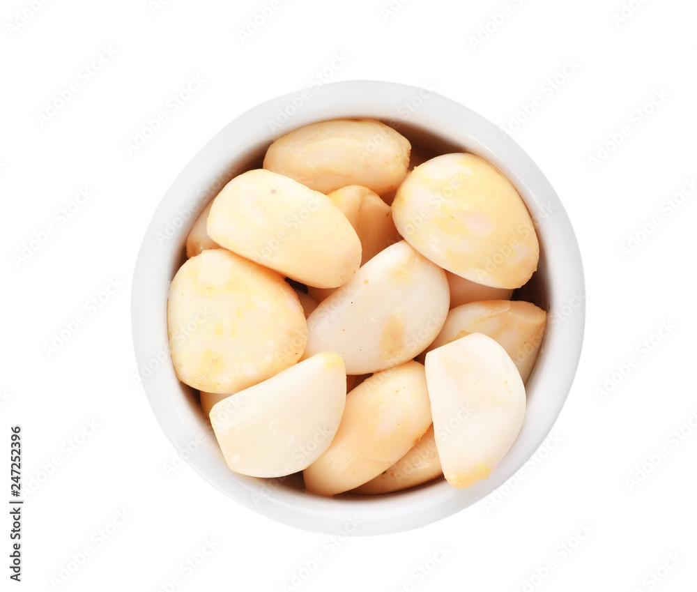 Bowl with preserved garlic on white background, top view Bowl with preserved garlic on white background, top view