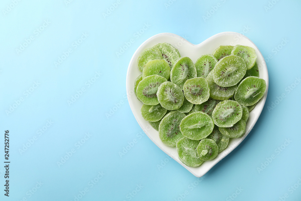 Plate of dried kiwi on color background, top view with space for text. Tasty and healthy fruit Plate of dried kiwi on color background, top view with space for text. Tasty and healthy fruit