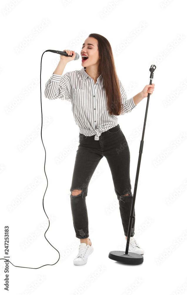 Young woman in casual clothes singing with microphone on white background Young woman in casual clothes singing with microphone on white background