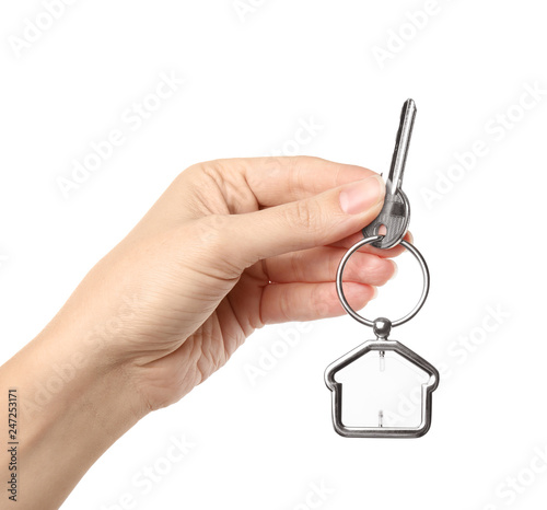 Woman holding house key with trinket on white background  closeup