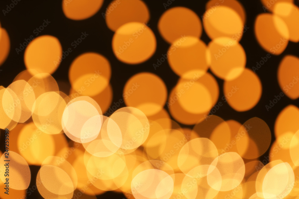 Beautiful golden lights on dark background. Bokeh effect Beautiful golden lights on dark background. Bokeh effect