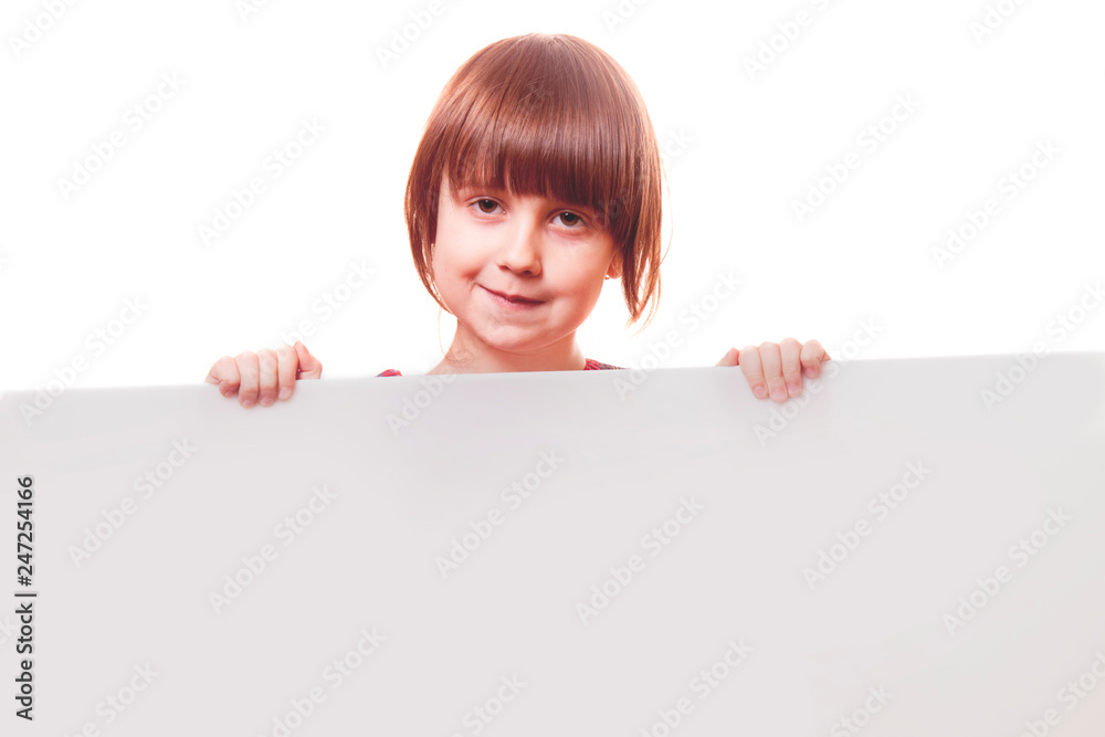 Happy funny little child girl laughing behind a white board. Space for text. Happy funny little child girl laughing behind a white board. Space for text.