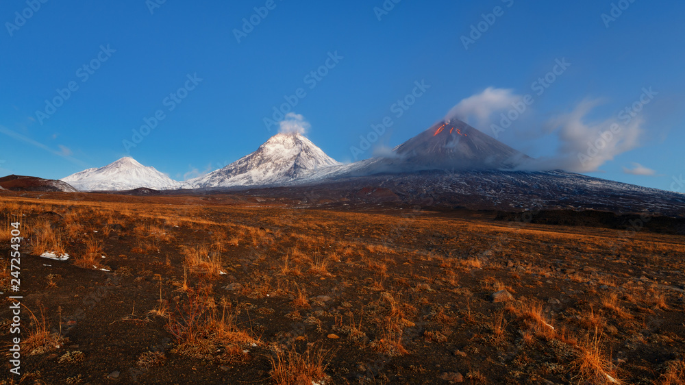 Autumn mountain panoramic landscape at sunrise of eruption active volcano