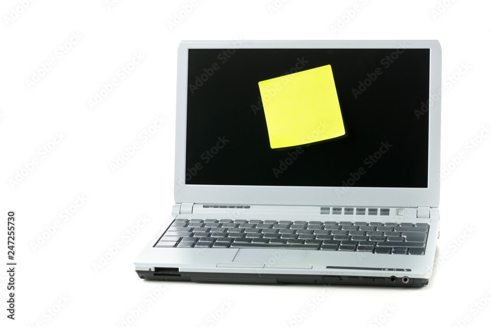 Empty yellow sticky paper note on laptop over white Empty yellow sticky paper note on laptop over white