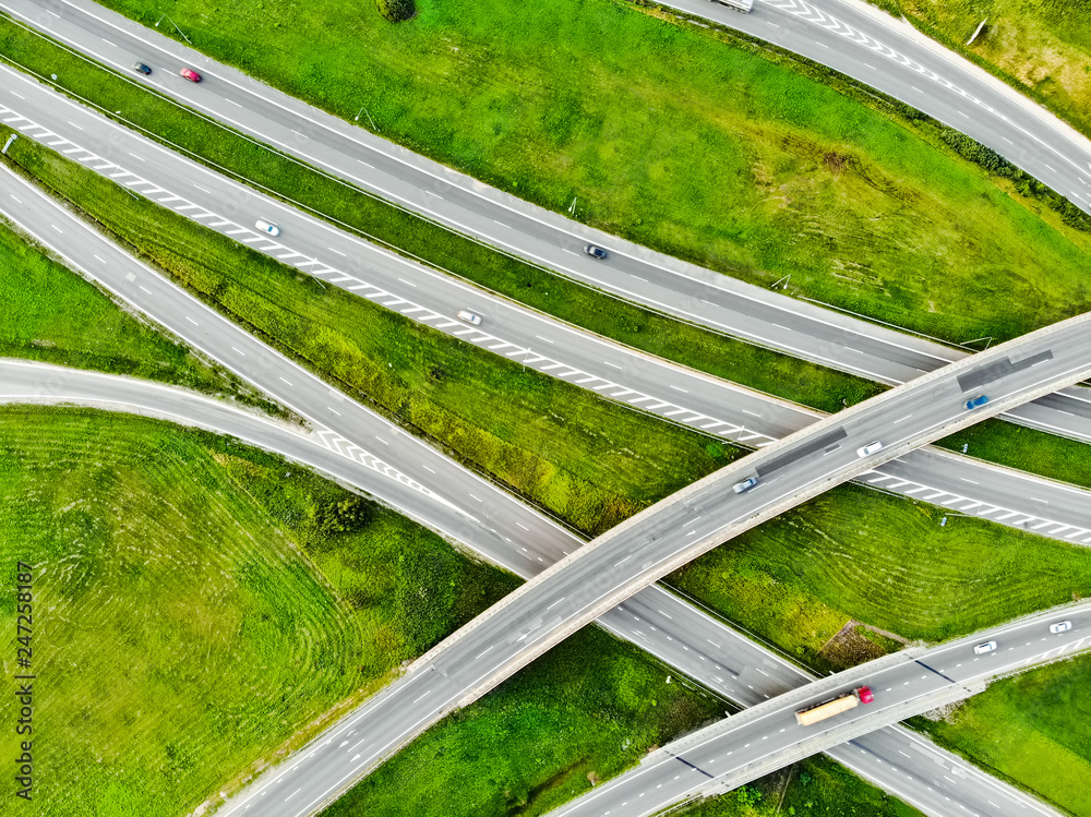 Aerial top down view of a highway road intersection. Cars passing, highway junction, cross roads.
