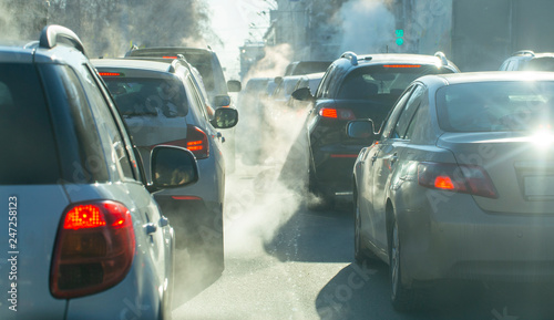 pollution from the exhaust of cars in the city in the winter. Smoke from cars on a cold winter day photo