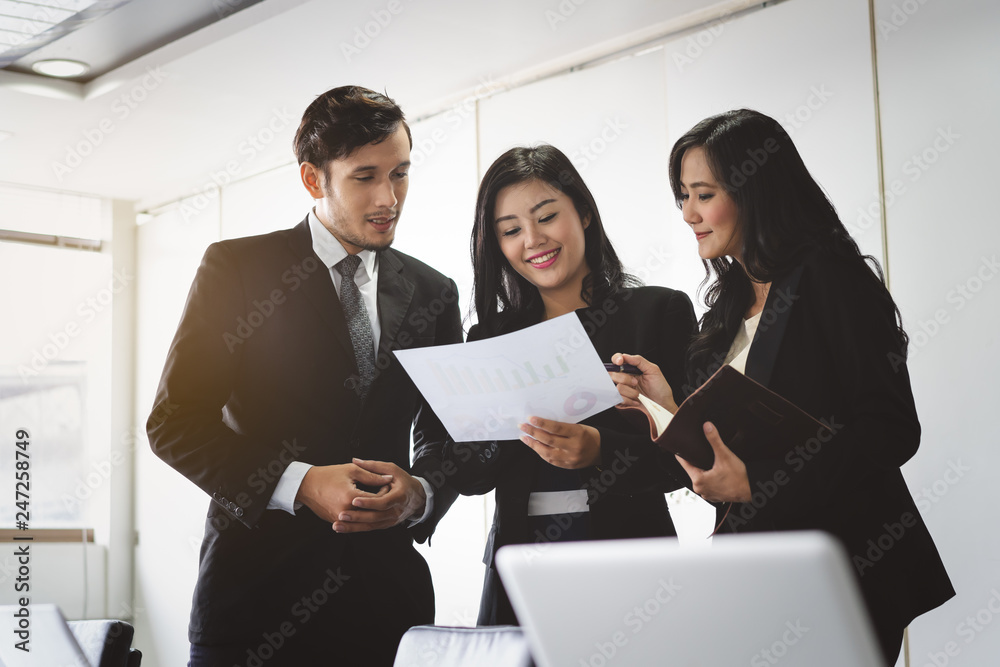 Marketing team consulting sales plan in conference room before meeting. Marketing team consulting sales plan in conference room before meeting.