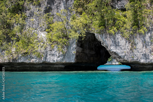 Arch in Rock Islands with Turquoise Blue Ocean and Tropical Plants