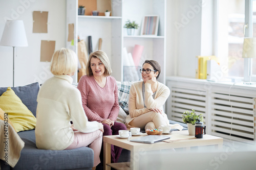 Картината върху платно Portrait of three adult women enjoying conversation during family evening at hom