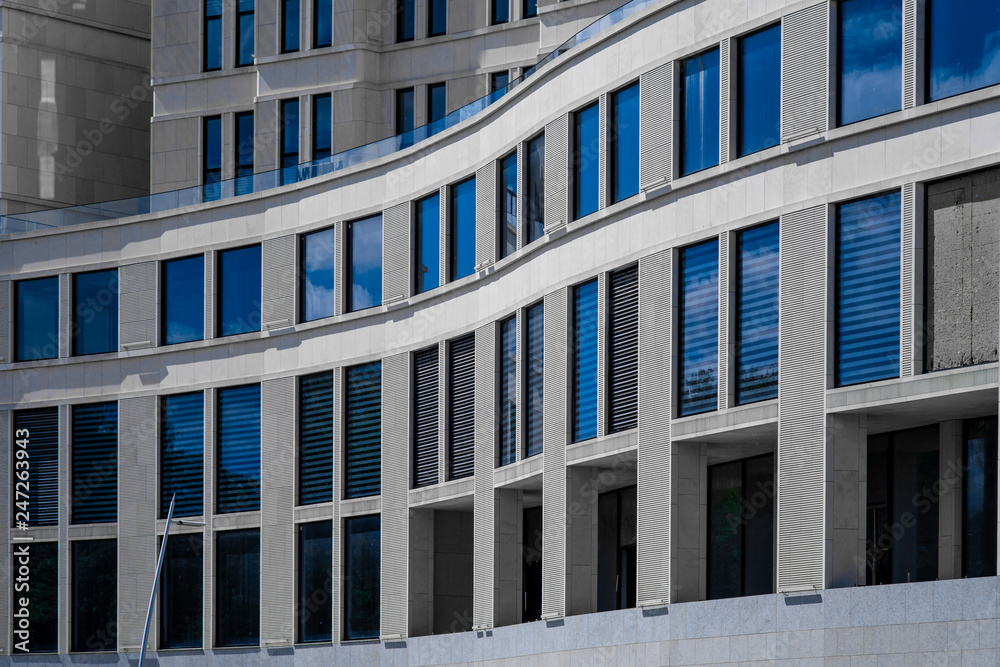 Part of modern office building with blue windows closeup. European architecture example
