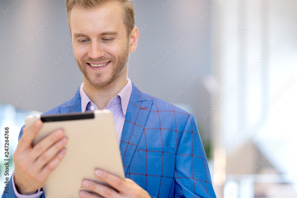 smart caucasian businessman hand hold tablet portrait with happiness and smiling with background of blur office smart caucasian businessman hand hold tablet portrait with happiness and smiling with background of blur office